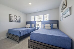 A bedroom with two beds, a ceiling light, and a window with blinds. - NMB Golf Retreat Near NMB Sports Complex (Little River)