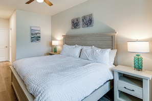 A bedroom with a large bed, two bedside tables, a nightstand, a ceiling fan, and wall art. - 5 Mi to Bethany Beach! Family & Pet-Friendly Haven (Frankford)