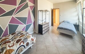 A bedroom with a bed, a dresser, and a wardrobe. - 2 bedroom stunning apartment in BOURBOURG (BOURBOURG)