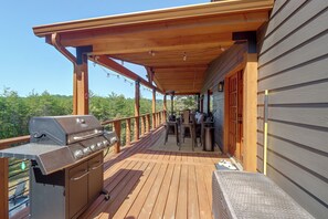 A wooden deck with a grill and outdoor furniture, overlooking a forested area. - Walk to Creek! 10-Acre 'Spring Creek Lodge' (Blue Ridge)