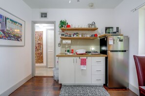 A compact kitchen with a refrigerator, microwave, and a small sink. - 'Chez Mercedes Suite' w/ Terrace in North Miami! (North Miami Beach)