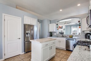 A modern kitchen with white cabinetry, stainless steel appliances, and a granite countertop. - Desert Oasis: Tucson Home w/ Private Swim Spa (Tucson)