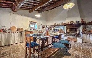 A rustic kitchen with wooden furniture, a stone floor, and a fireplace. - 3 bedroom lovely home in Cagli (Cagli)
