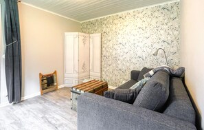 A living room with a grey sofa, a wooden chest of drawers, and a white wardrobe. - Lovely home in Vessigebro with house a panoramic view (Vessigebro)