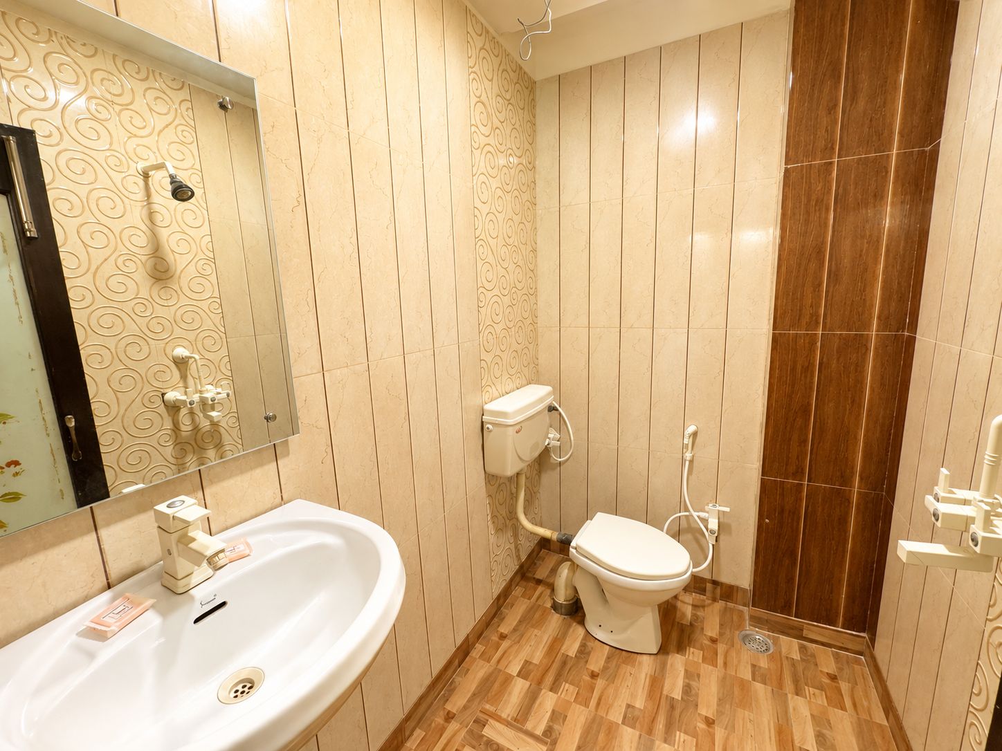 A bathroom with a sink, toilet, and shower.