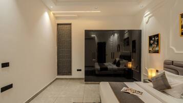 A modern bedroom with a bed, bedside table, and a mirror.