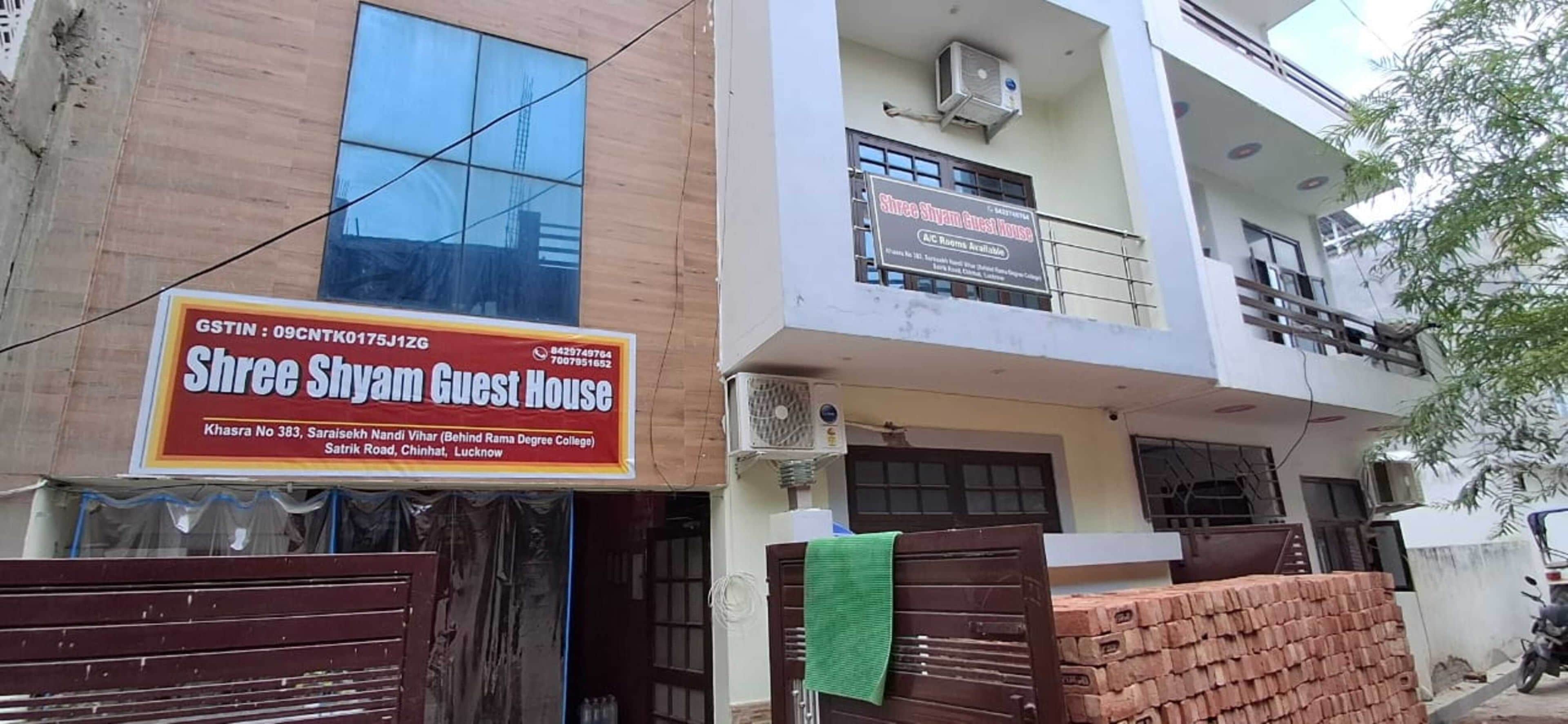 A two-story building with a sign for 'Shree Shyam Guest House' indicating it is a guest house.