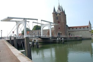 A historic bridge with a tower, a lock system, and a waterfront walkway. - Chalet for 2 to 4 people Cosy (Renesse)
