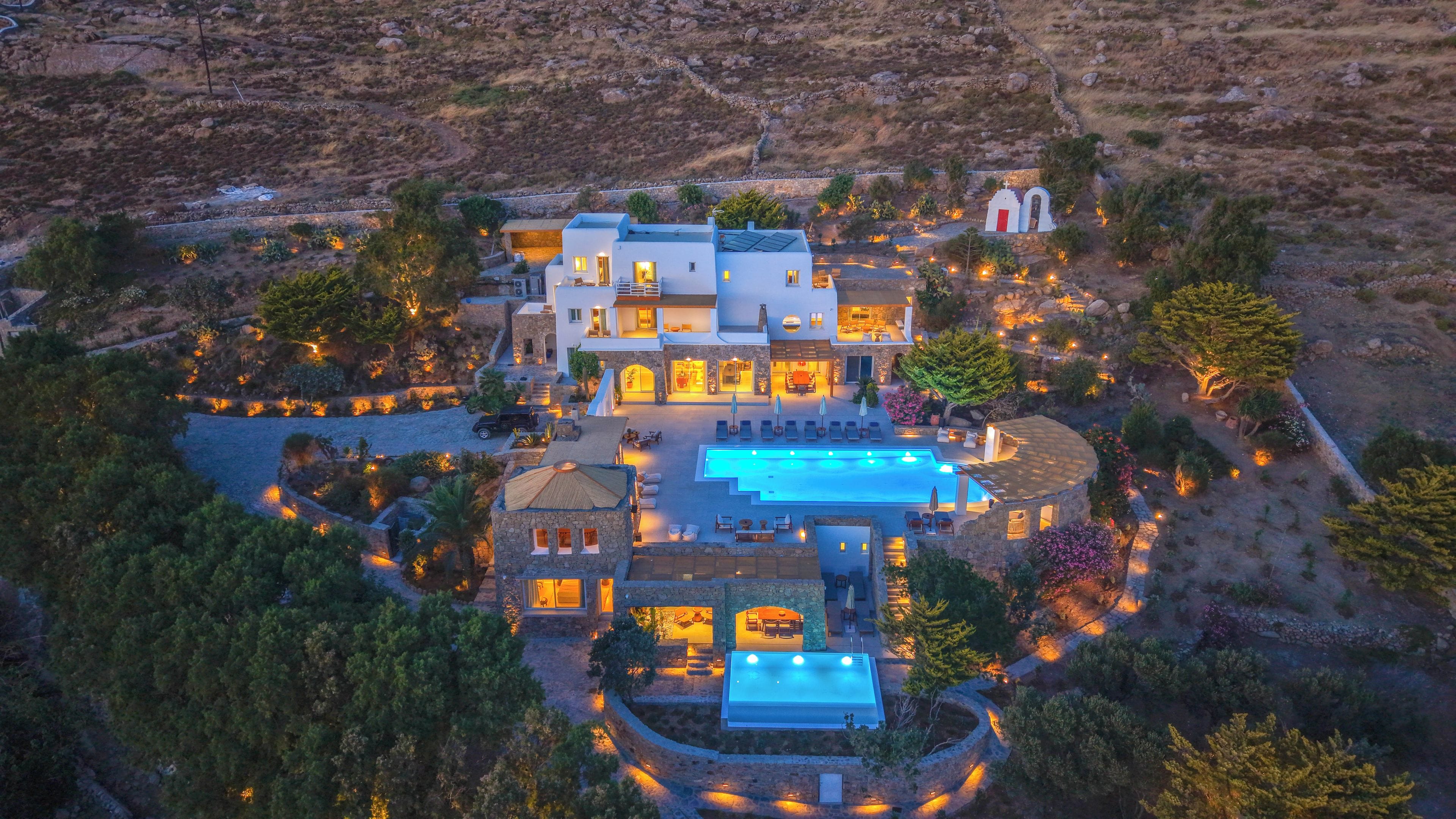 A large estate with multiple buildings, a swimming pool, and landscaped gardens.