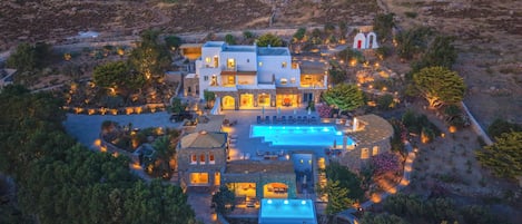 A large estate with multiple buildings, a swimming pool, and landscaped gardens.
