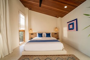 A bedroom with a large bed, wooden ceiling, and a window with curtains. - Villa GIGI Balangan (Balangan)