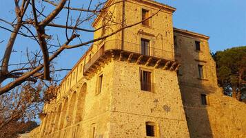 A historic stone building with multiple windows and a balcony.