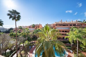 Ein Resort mit mehreren Gebäuden, einem Pool und Palmen.