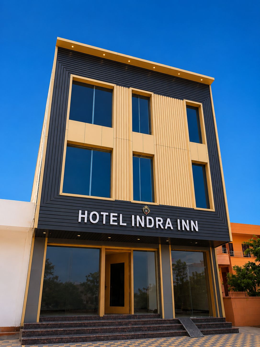 A modern hotel building with a prominent sign reading 'HOTEL INDRI INN.'