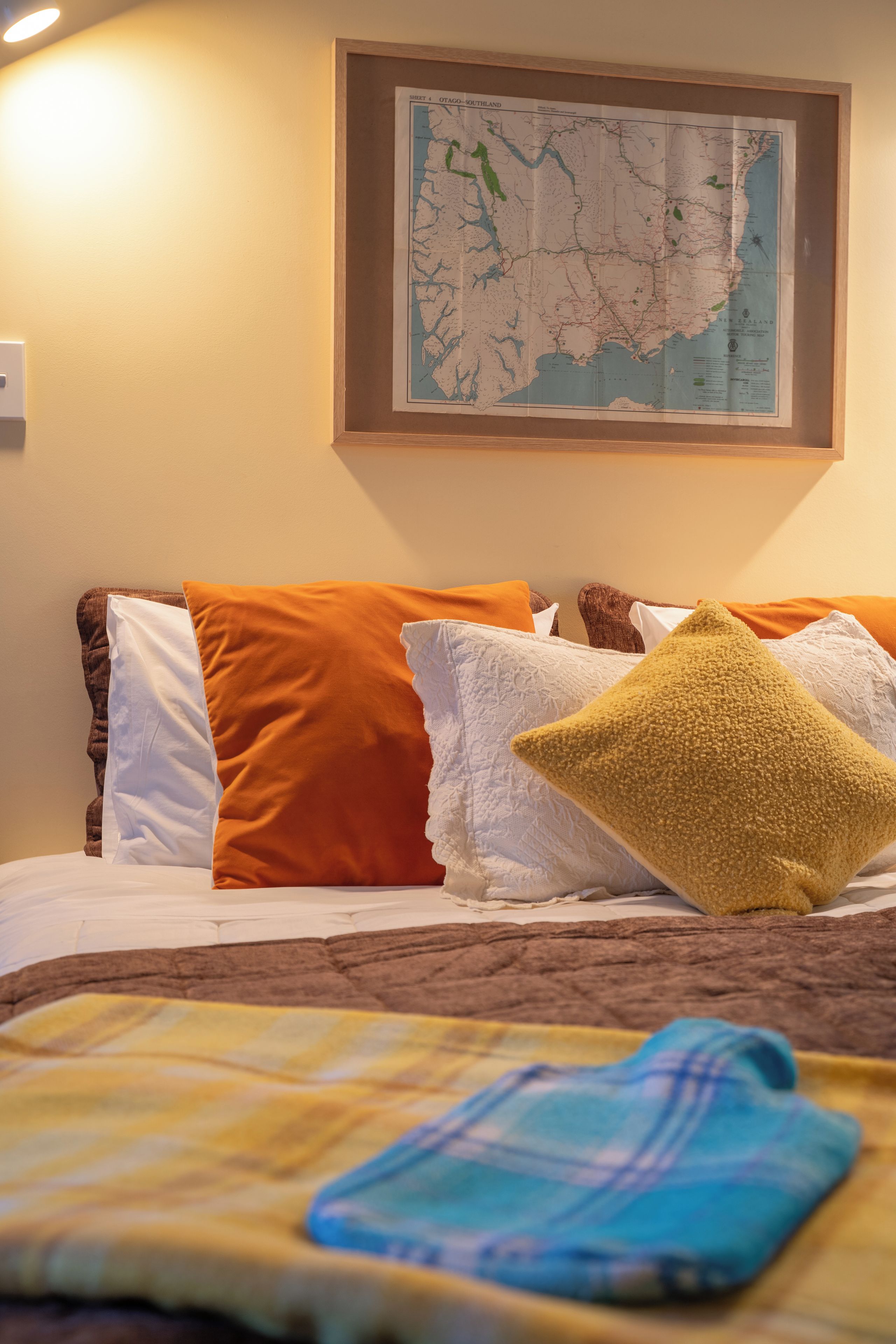 A bed with a map on the wall above it.
