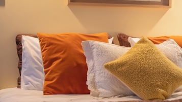 A bed with a map on the wall above it.
