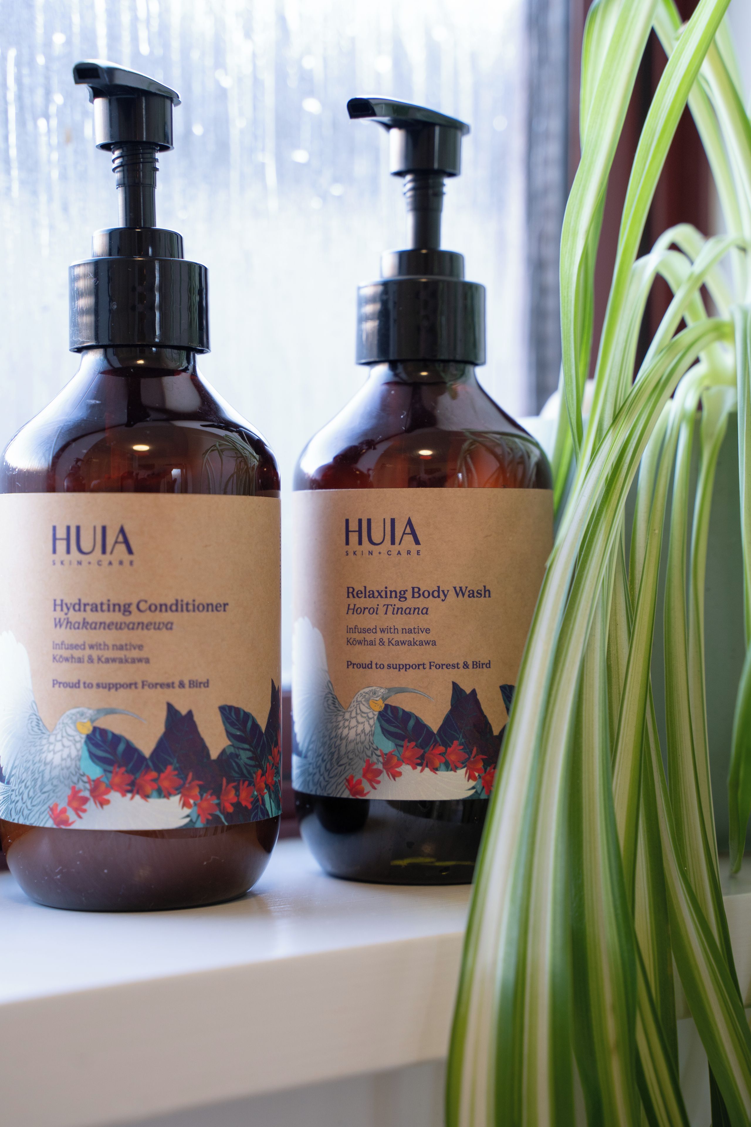 Two bottles of HUIA skincare products on a shelf.