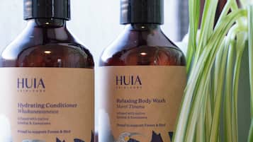 Two bottles of HUIA skincare products on a shelf.