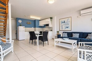 A modern apartment with a dining area, kitchen, and living room. - Breeze at Fly Point Apartment 39 (Nelson Bay)
