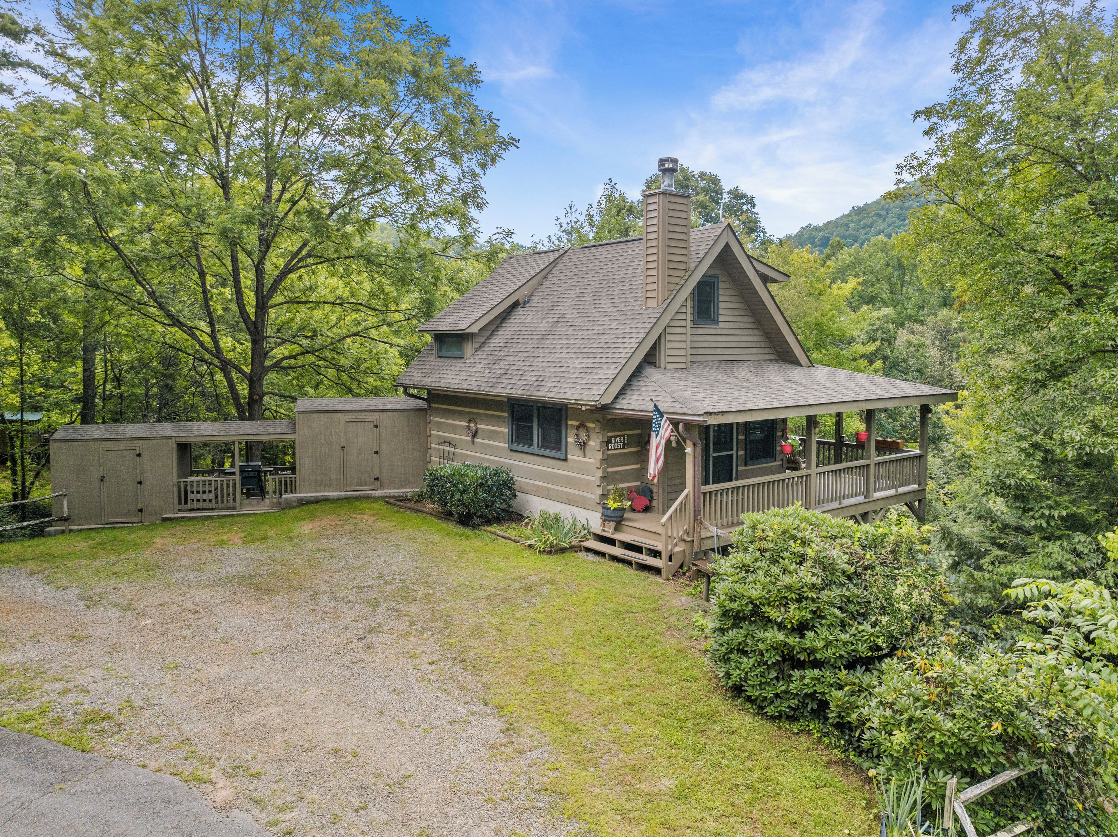 A two-story house with a porch, a shed, and a well-maintained lawn.