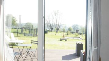 A room with a sliding glass door leading to an outdoor deck area.