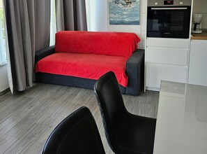 A modern living area with a sofa, a coffee machine, and a view of the outdoors. - Mary Apartments & Pool (Trogir)