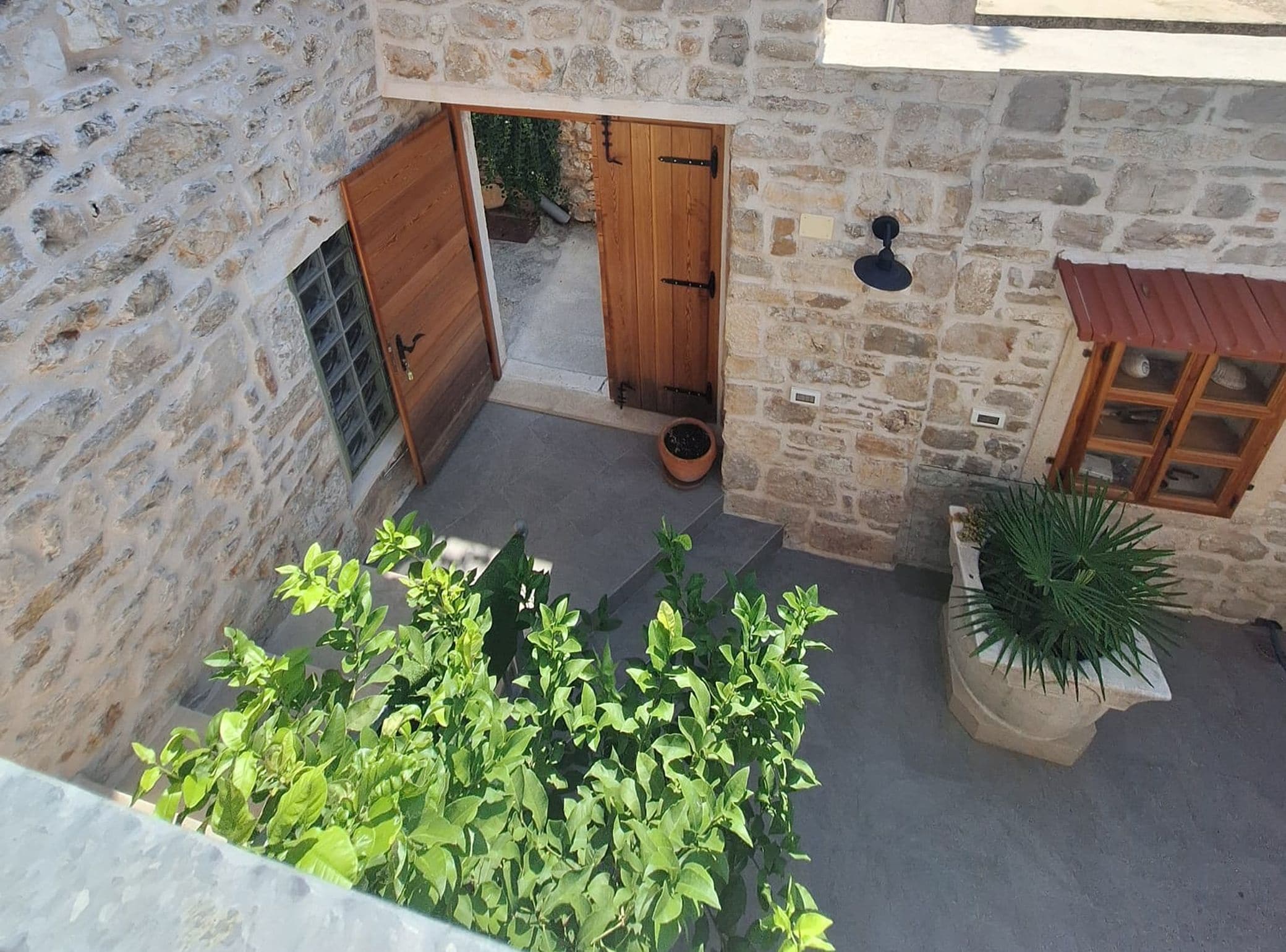 A stone building with a wooden door and a small window.