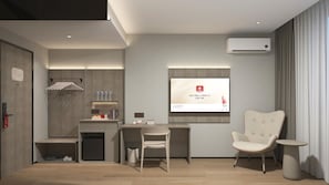 A modern hotel room with a desk, chair, and a flat-screen TV mounted on the wall. - SHANKEE Hotel M Blok Jakarta (Jakarta Selatan)