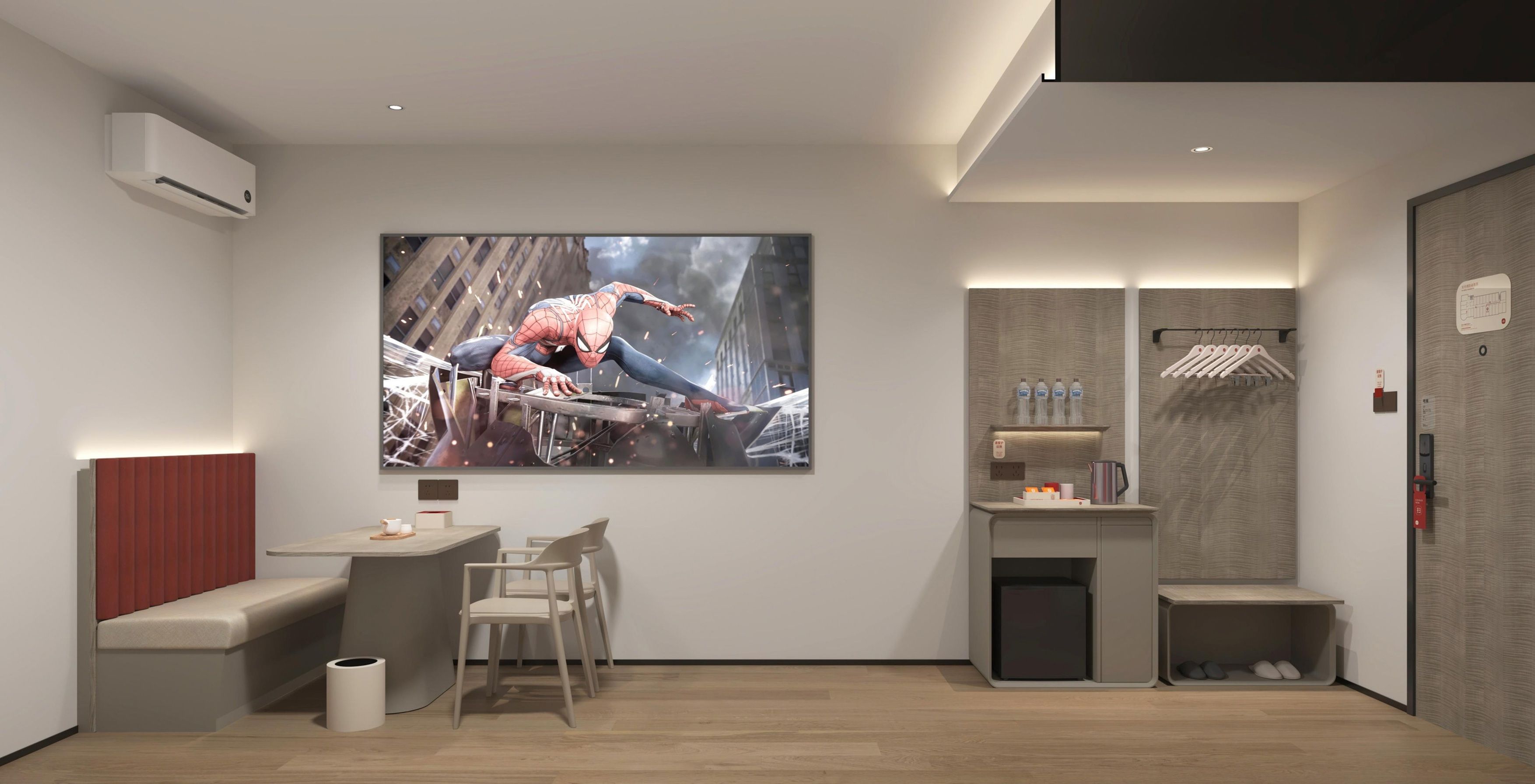 A modern room with a large Spider-Man artwork on the wall, a small seating area, a desk, and a built-in shelf with toiletries.