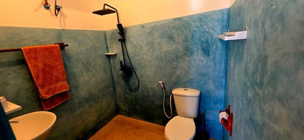 A bathroom with a shower, toilet, and sink.