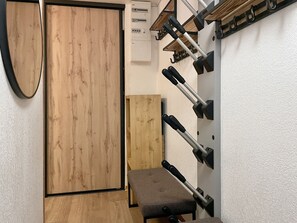 A room with a wooden door, a bench, and a wall-mounted rack with hooks. - (VM.308) 4-room PREMIUM - Alpine Style - (Les Menuires)