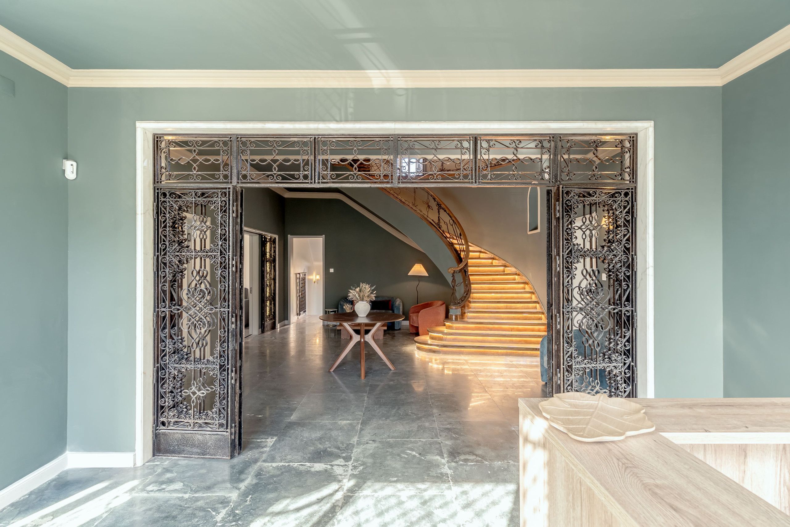 A hallway with a staircase leading to a second floor.