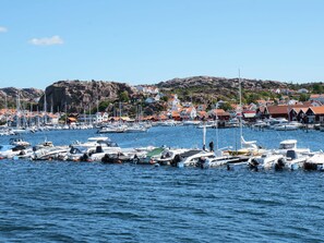 A marina with boats docked, surrounded by houses with red roofs. - 8 Person Holiday Home in Bovallstrand (Bovallstrand)