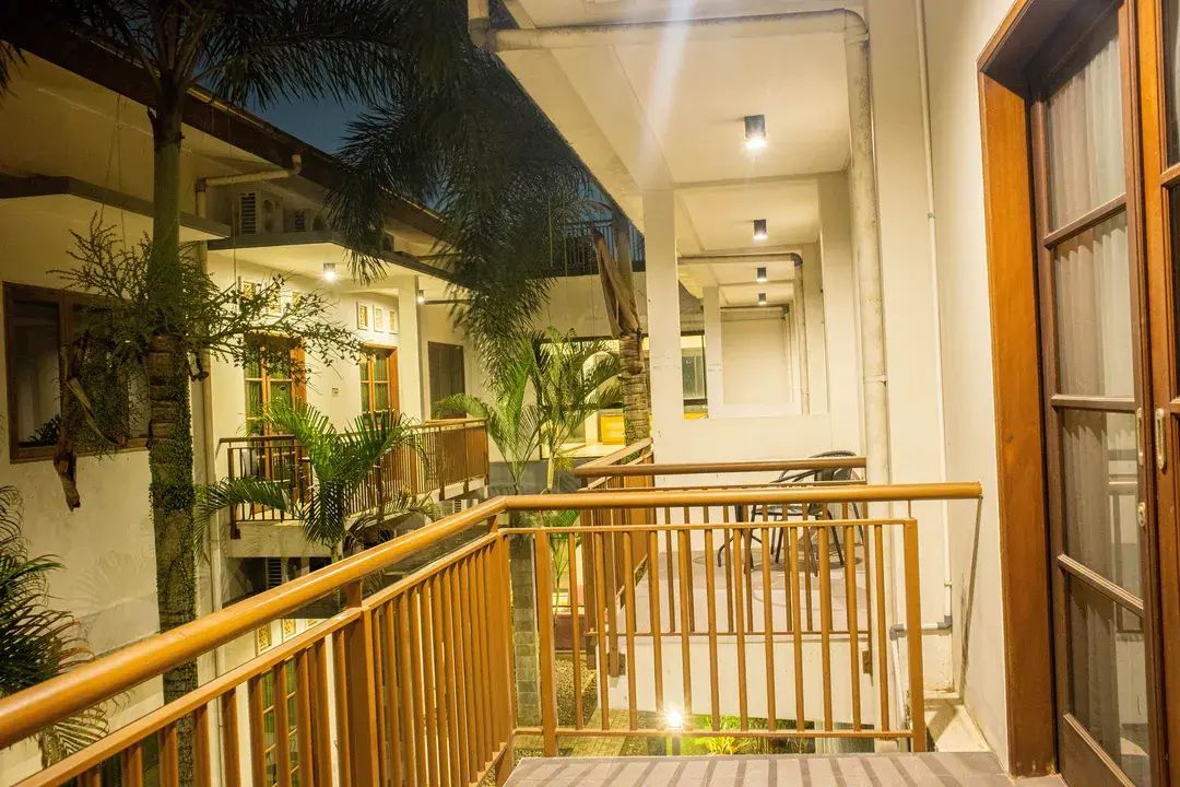 A multi-level building with outdoor seating areas, a staircase, and a railing.