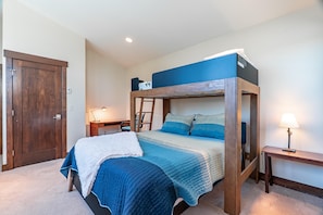 A bunk bed with a headboard, a desk with a lamp, a chair, and a wardrobe. - Tabernash Retreat | 3BR, Hot Tub, Mtn Views (Tabernash)