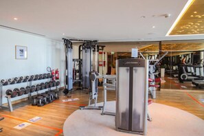 A gym with various exercise equipment, including dumbbells, a cable machine, and treadmills. - Sky Level 2BR with Harbour View, Just a Quick Drive to Downtown AttractionsSky Level 2BR with Harbour View, Just a Quick Drive to Downtown Attractions (Dubai)