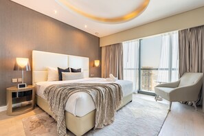 A modern hotel room with a large bed, bedside lamps, a chair, and a view of the city. - Sky Level 2BR with Harbour View, Just a Quick Drive to Downtown AttractionsSky Level 2BR with Harbour View, Just a Quick Drive to Downtown Attractions (Dubai)