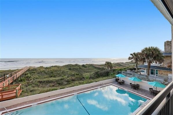 A pool with a view of the beach and a palm tree. - Beacher's Oceanfront Balcony, Condo Complex Construction 10/2026-1/2027 (St. Augustine)