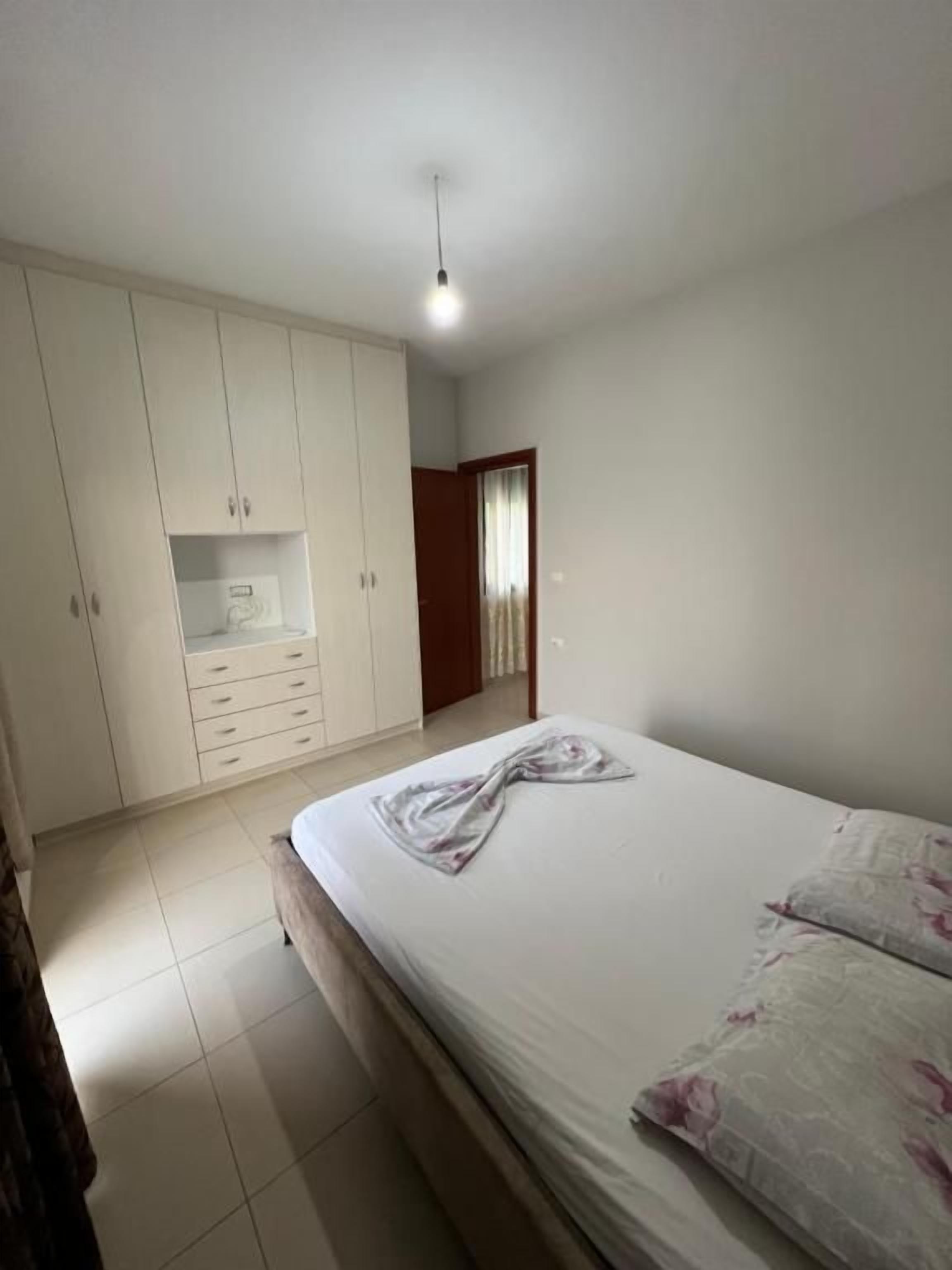 Un dormitorio con cama, armario y puerta que da a otra habitación.