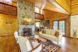 A spacious living room with a stone fireplace, wooden ceiling, and a cozy seating area. - Walk to Creek! 10-acre 'spring Creek Lodge' (Blue Ridge)