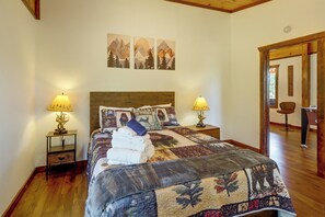 A neatly made bed with a patterned bedspread, two bedside lamps, and a wall with three framed artworks. - Walk to Creek! 10-acre 'spring Creek Lodge' (Blue Ridge)