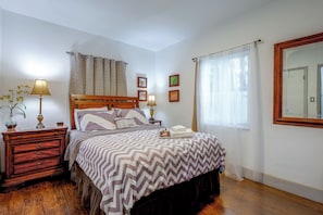 A neatly arranged bedroom with a bed, bedside tables, lamps, and a mirror. - 'chez Mercedes Suite' w/ Terrace in North Miami! (North Miami Beach)