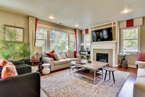 A living room with a fireplace, a television, and a sofa.