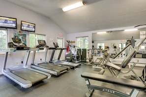 A gym with treadmills, ellipticals, and weight machines.