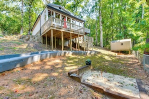 A two-story house with a wooden deck and a small attached cabin. - Game & Theater Rooms! Lake Hartwell Family Oasis (Lavonia)