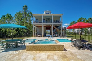 A two-story building with a balcony, a swimming pool, and outdoor seating. - Play & Unwind! Pass Christian Home < 1 Mi to Gulf (Pass Christian)