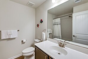 A bathroom with a white sink, toilet, and a large mirror. - 5 Mi to Bethany Beach! Family & Pet-friendly Haven (Ocean View)