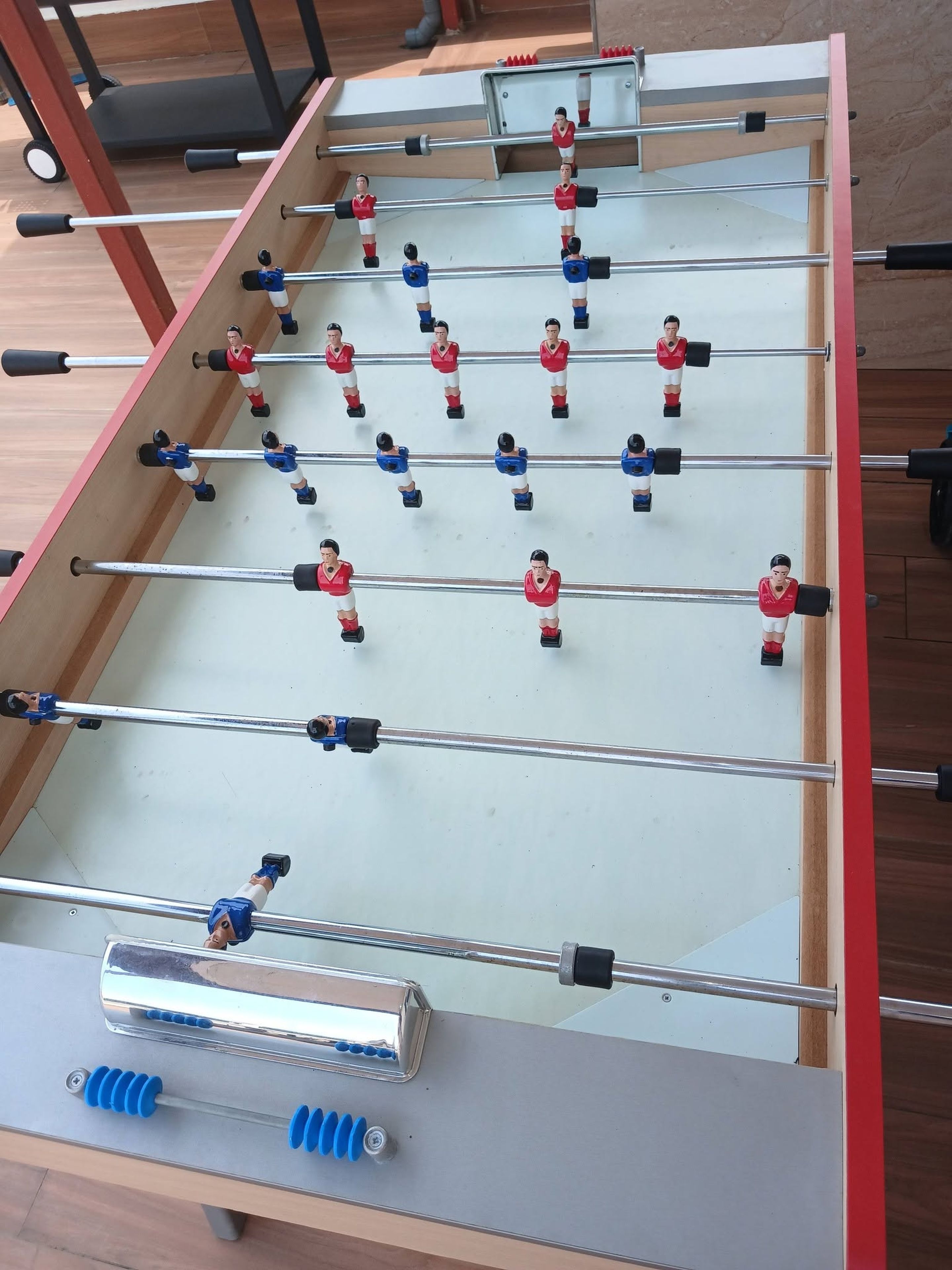 A foosball table with multiple players and rods.