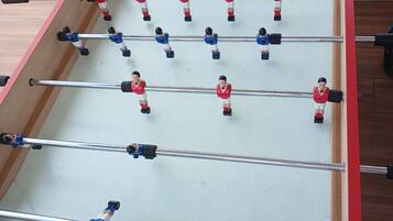 A foosball table with multiple players and rods.