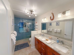 A bathroom with a double sink vanity, a large mirror, and a ceiling fan. - Sweeping Ocean & Koko Head Views - Ridgetop Home (Honolulu)